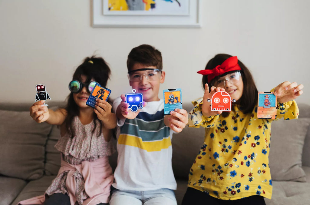 Kids showing off their finished CircuitMess STEM kits