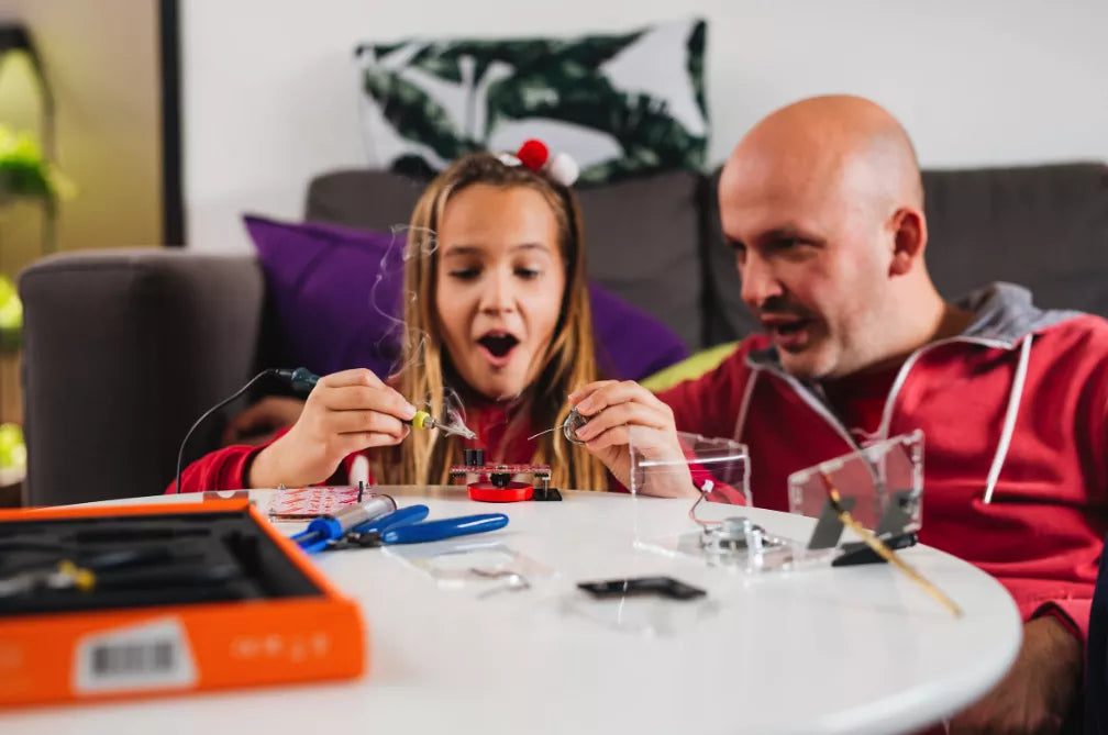 Girl soldering an electronics gadget