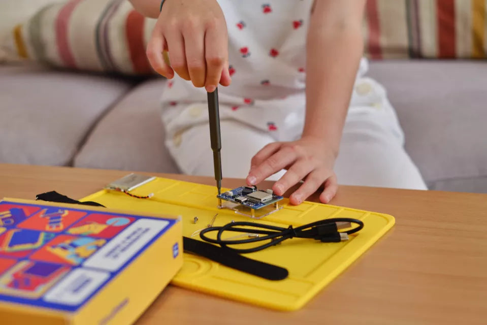 Girl assembling a DIY electronics gadget