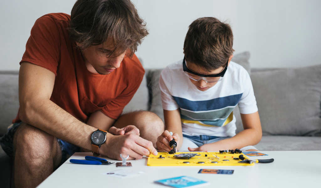 Dad and son building robots