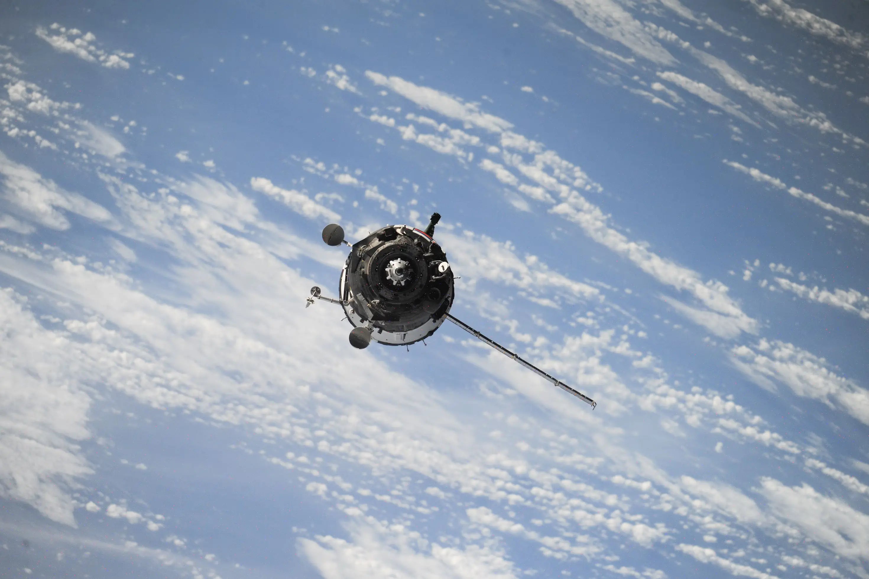 A real photo of a satellite far above the Earth in orbit