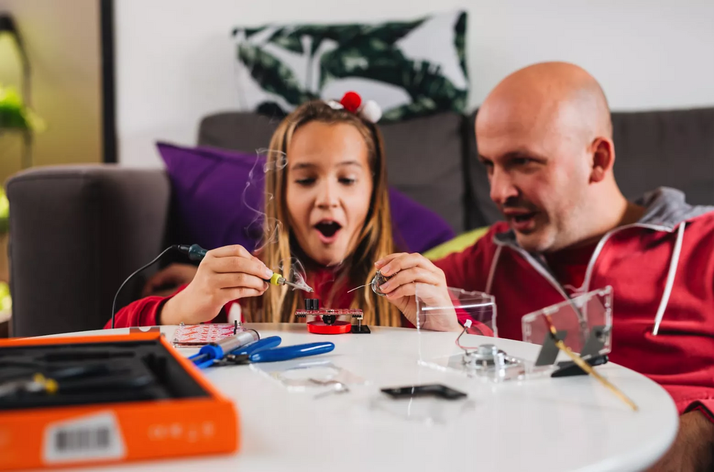 Girl soldering CircuitMess Spencer - science kit for kids