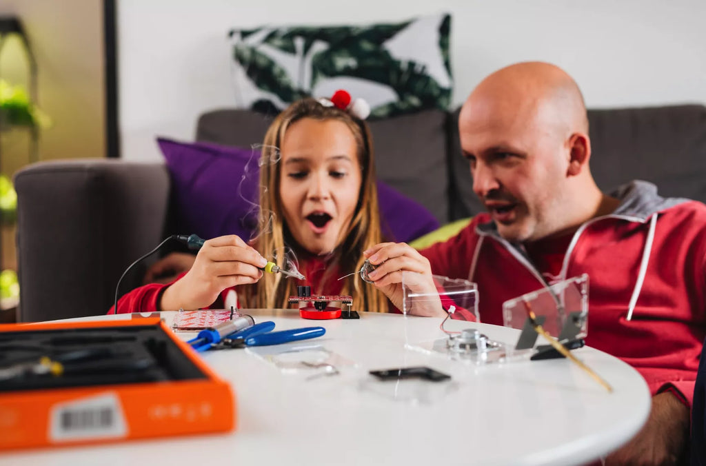 Parent watching their kid enjoy with CircuitMess kits