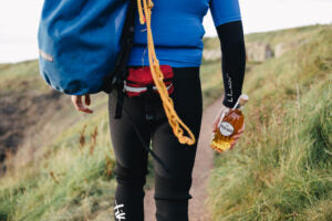 Male hiker carrying a bottle of River Rock single malt whisky