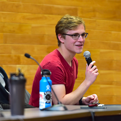 Jonas of the Wayside Wizard speaking at an event at UW Madison