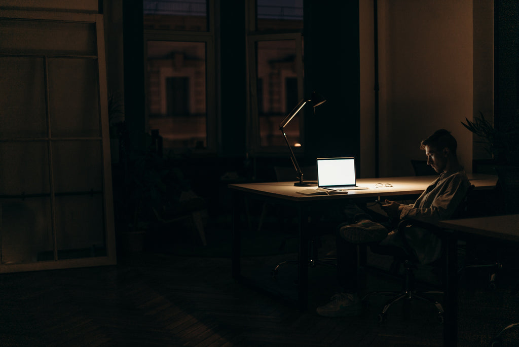 Man working late at night in the dark