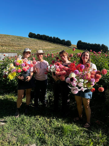 Group of MFM staff holding bouquets at Thanisa's farm in Plenty Valley