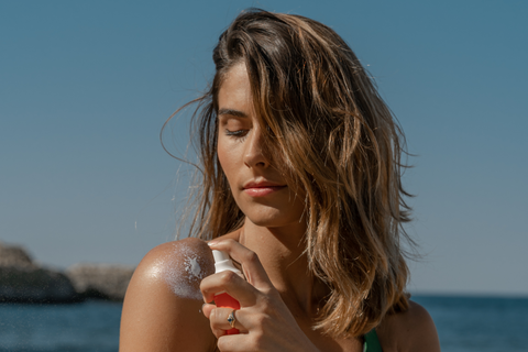 Woman applying biodegradable sunscreen