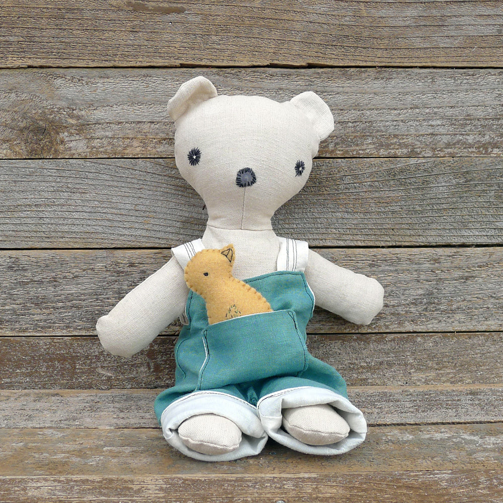 teddy bear with green overalls