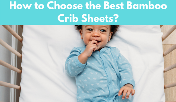 a baby with smile face laying in the best bamboo baby crib sheets