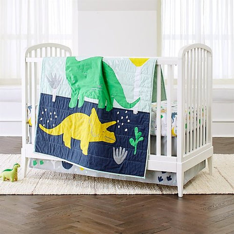 Dinosaur baby quilt over crib
