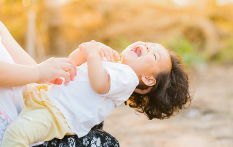 Little boy being tickled by parent