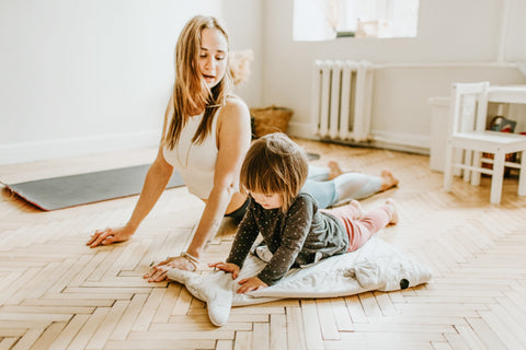 Mom and daughter doing yoga together