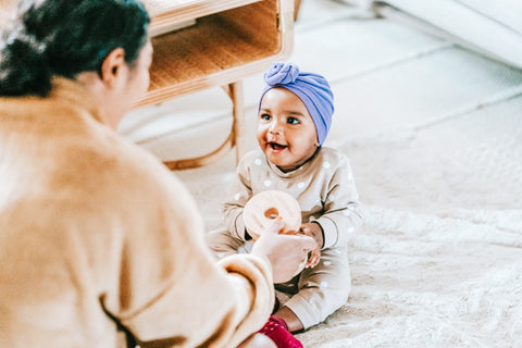 Baby playing with mom