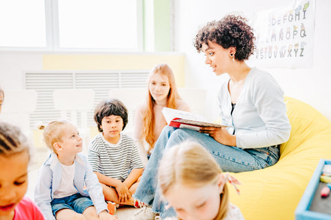 Kids in school having a book read to them