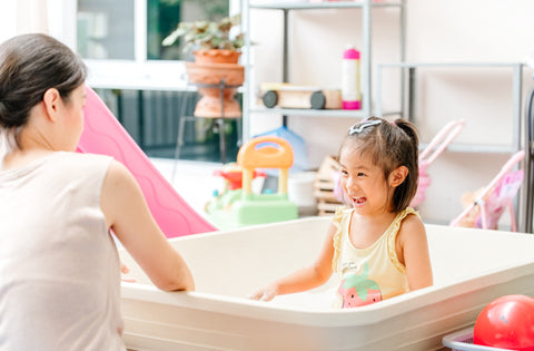 Asian daughter sitting in craft room