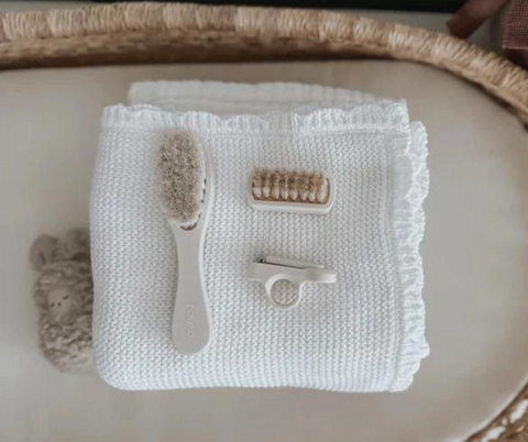 Jolie trousse de toilette pour bébé de la marque Noüka, comprenant brosse à cheveux, brosse à ongles et coupe-ongles