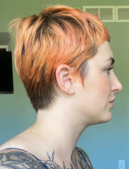side profile of woman with short orange hair