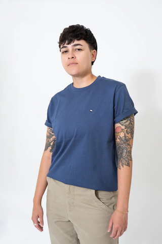 Short haired person wearing blue teeshirt made by Peau De Loup