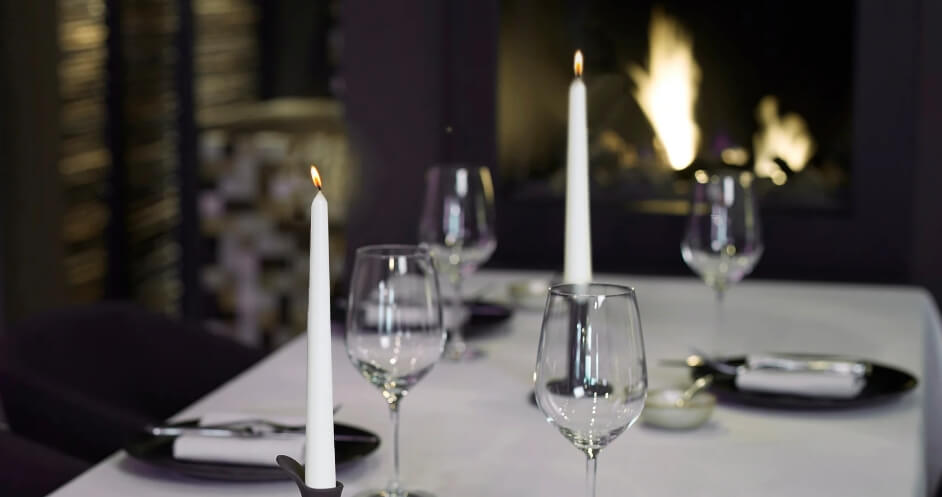 Candles on a table set for a formal dinner