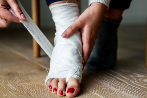 woman sitting bandage wrapped around her foot