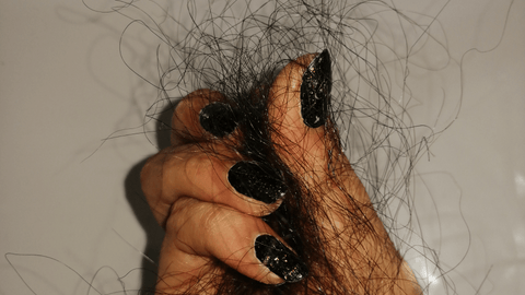 Photo of a girl holding hair strands
