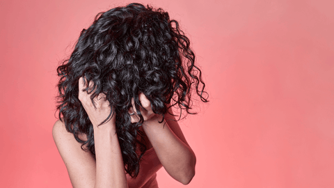 image of a girl crunching her curly hair