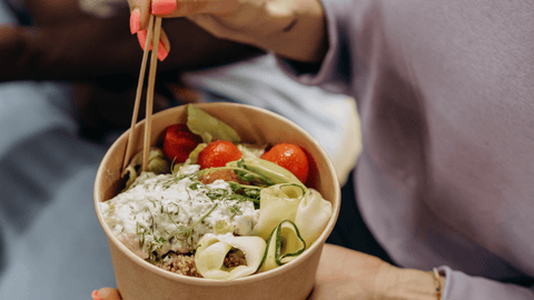 Person eating a healthy salad bowl