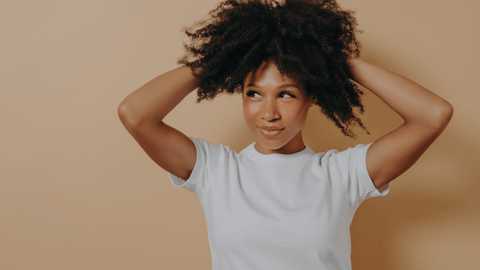 Ethnic girl with curly kinky hair looking into distance