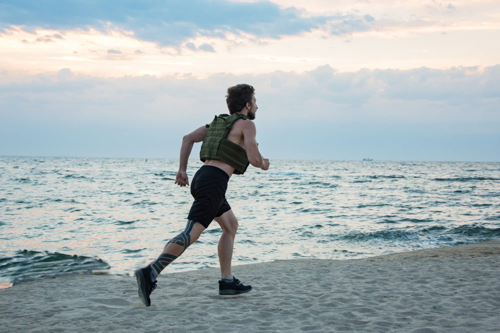 A man running in a weighted vest.