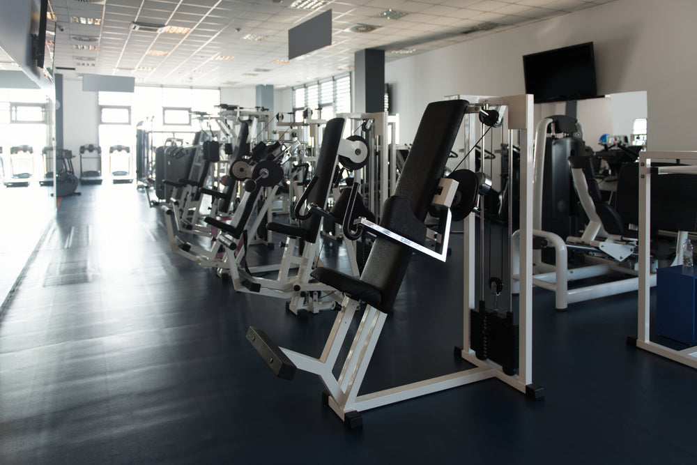An image of machine weights in a gym
