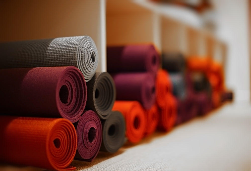 A picture of yoga mats stacked on top of each other.