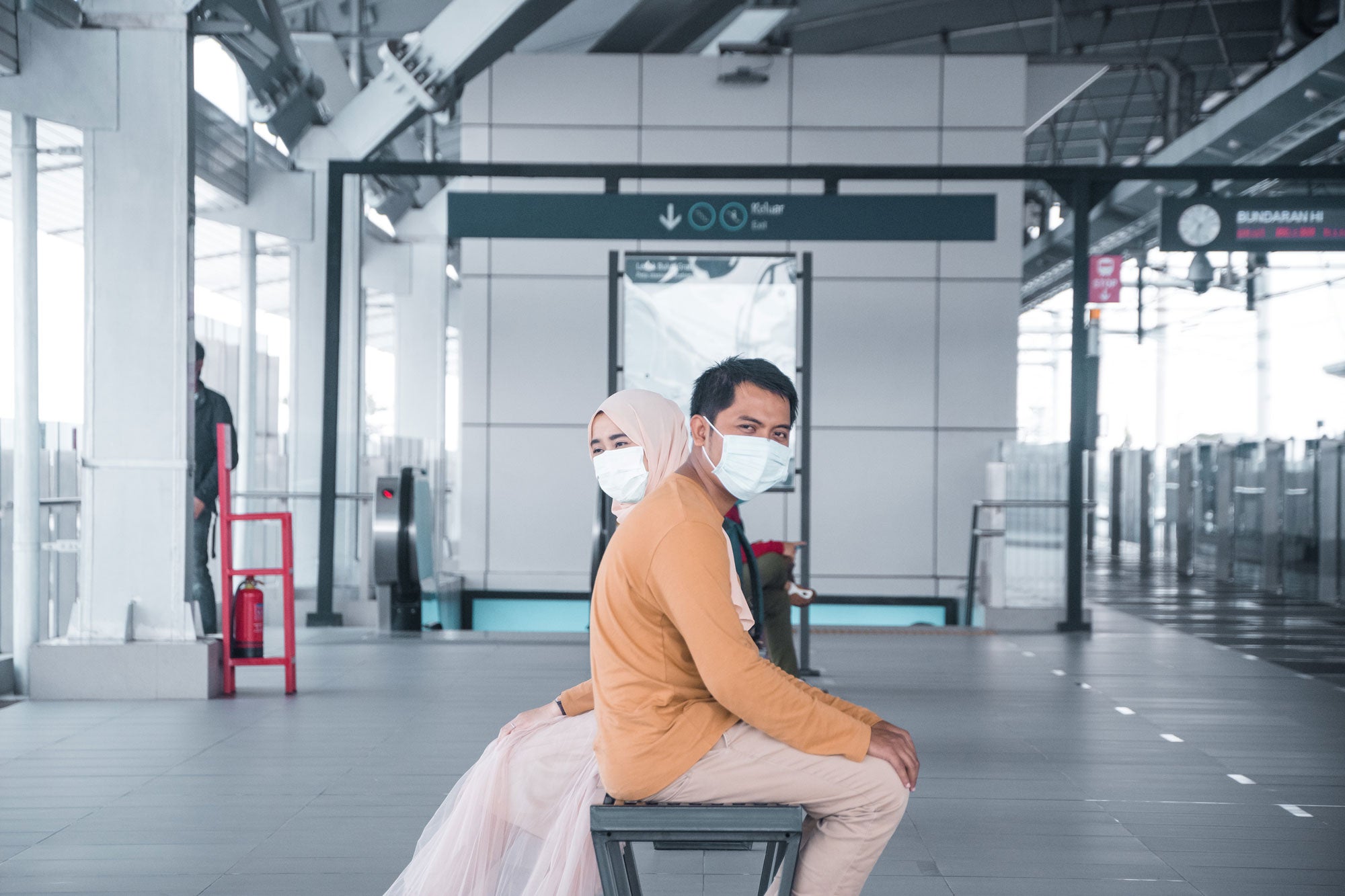 Couple in the airport wearing facemask