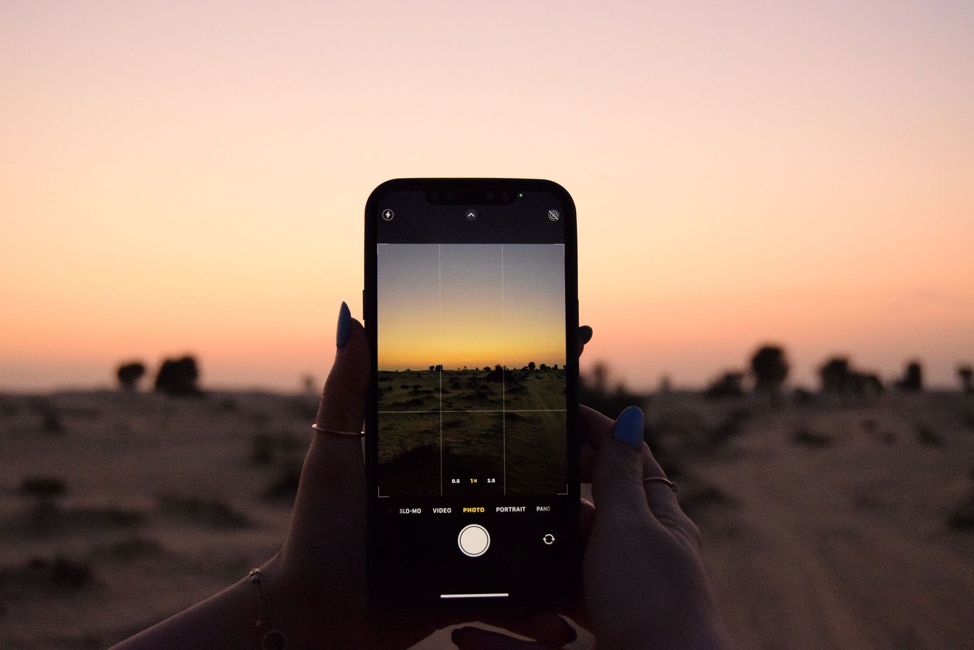 Taking a photo of the sunset using iPhone Camera with Grid Feature