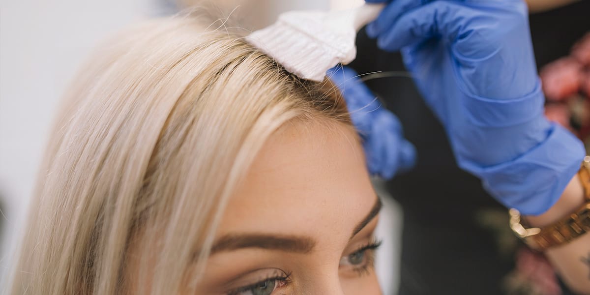 Lady getting a hair colour treatment at the hair salon