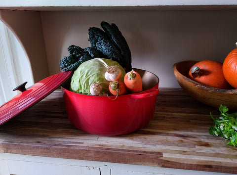 Red soup pot filled with vegetables