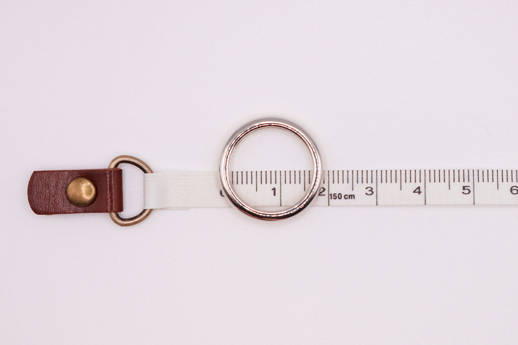 Silver ring on a measuring tape for size measurement