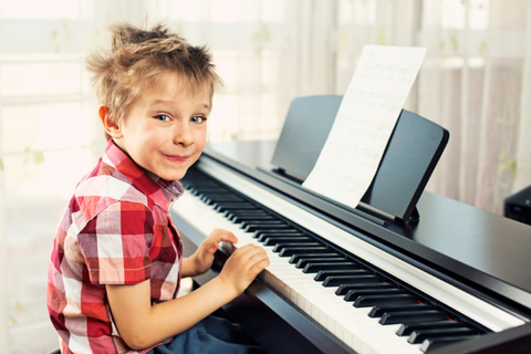 Child playing a digital piano