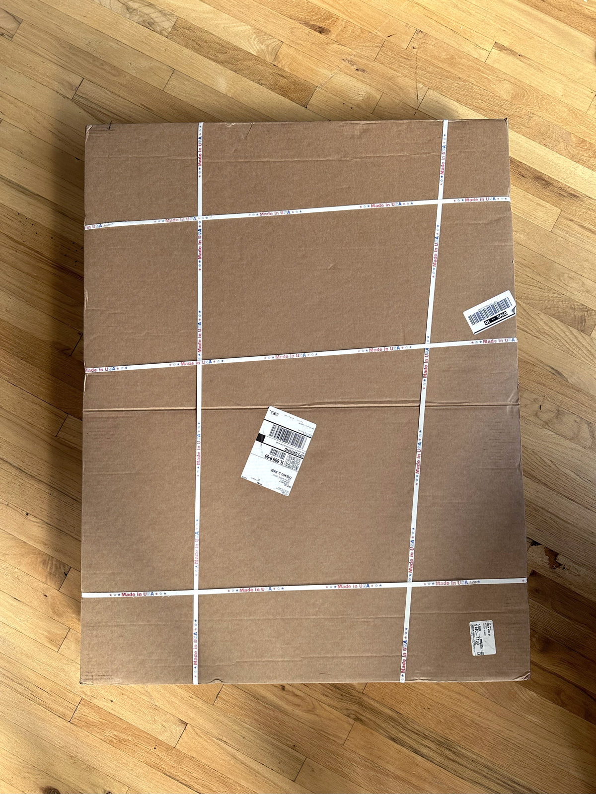 A cardboard box with plastic strapping on the outside