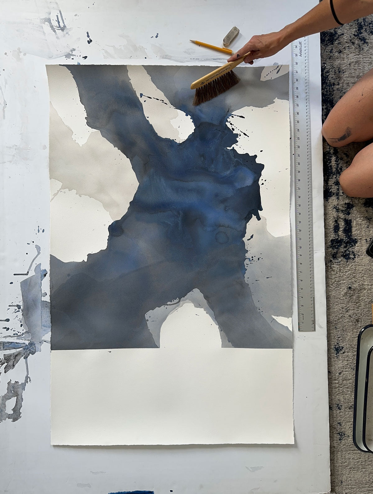 A painting on paper with organic fluid shapes of dark blue-grey on top of grey