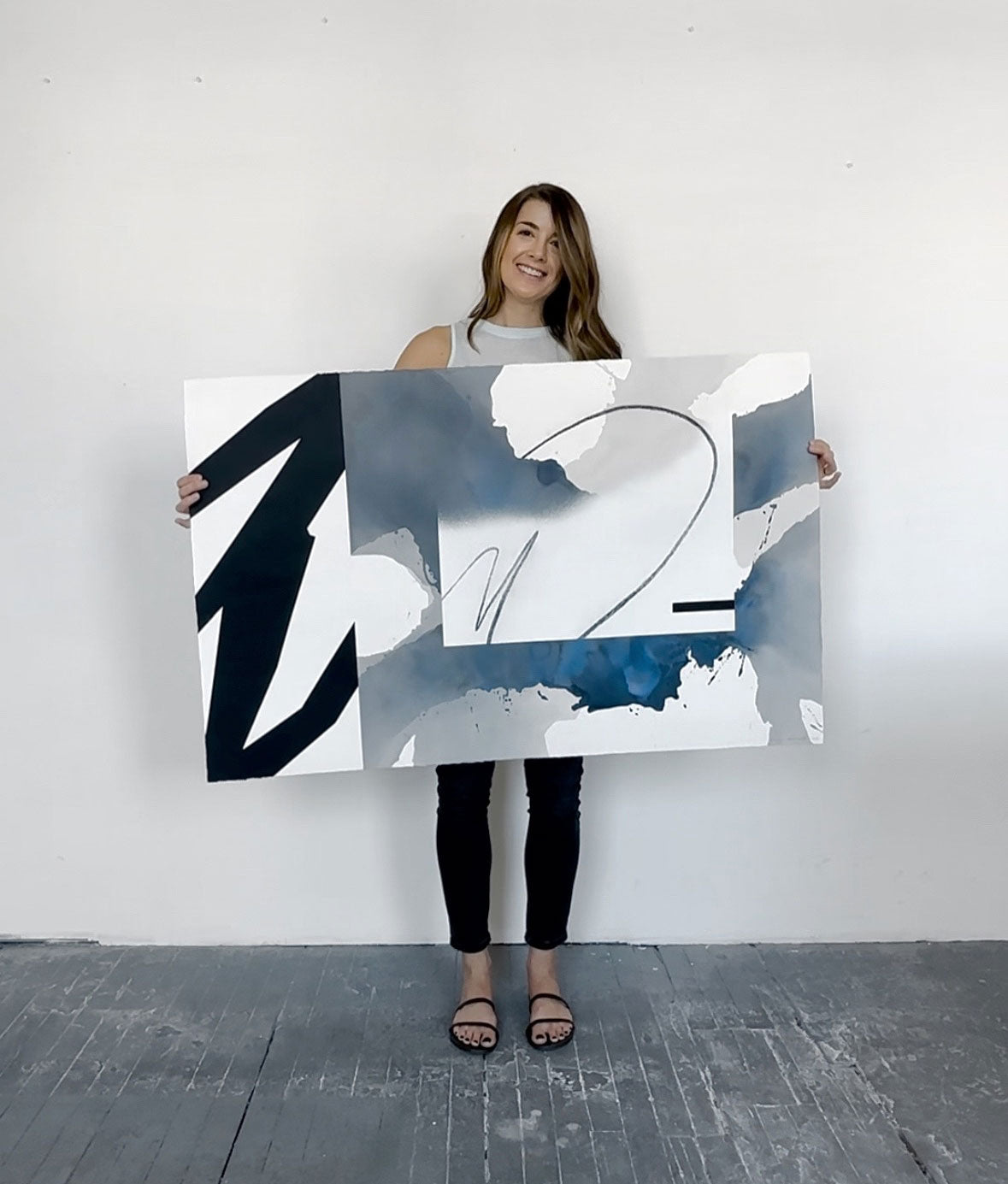 Kim Knoll holding the Boundless painting