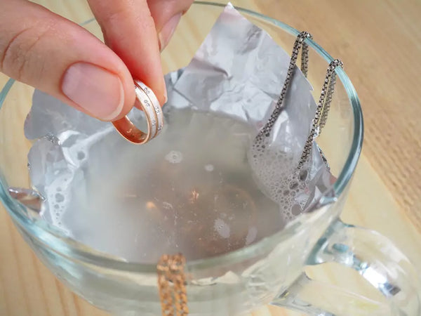 introducing water into a container for cleaning jewelry