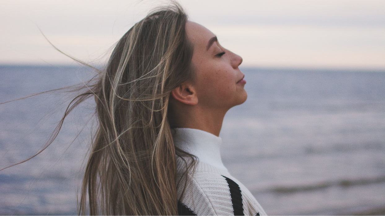 Woman breathing on the beach