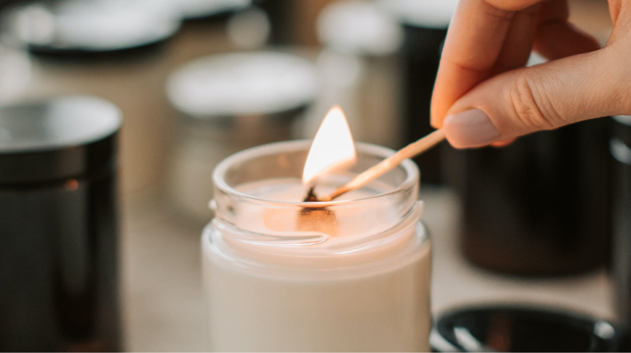 Someone lighting a sustainable candle