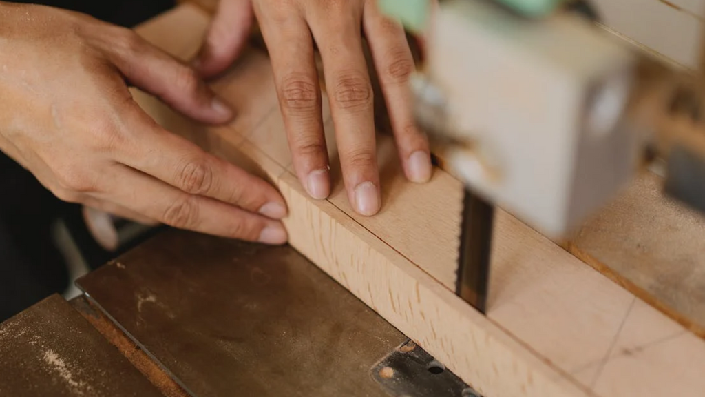 After fastening your table legs to the jig with two pieces of plywood in Step 5, begin sawing them into a tapered form