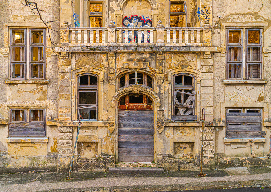 ic:The front facade of this abandoned Croatian hotel exudes an eerie beauty, its forsaken grandeur and dilapidated elegance standing as a testament to the transient nature of human endeavors and the enduring allure of architectural decay.