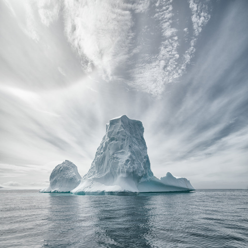 ic:Frozen Elegance: An Antarctic Iceberg Under Wispy Skies