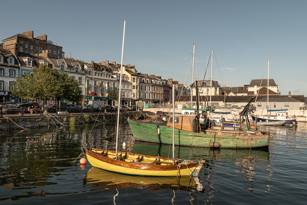 ic:Sunset Serenity: Cobh's historic harbor basks in the golden glow of sunset, embodying Ireland's picturesque charm and maritime heritage.