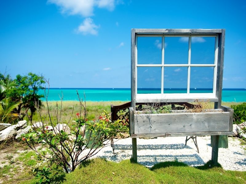 Creative window frame decoration with view to ocean