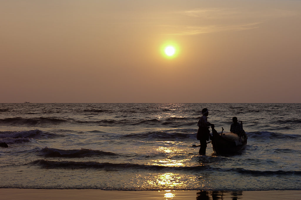 ic:Fishermen set of to sea at sunrise in India